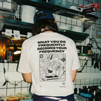 Person wearing a t-shirt with a graphic and text in a kitchen setting
