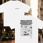 White t-shirt with graphic design and text on a city street background