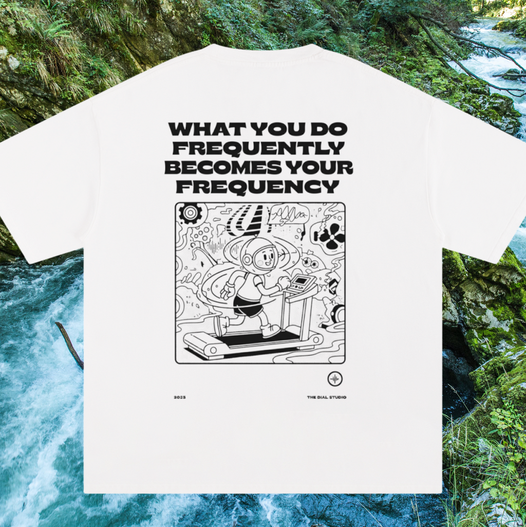 White t-shirt with black graphic and text in a natural setting